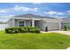 Well-maintained gray home features a lush green lawn and an attached garage at 1976 Harvest Landing Cir, Lakeland, FL 33810