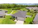 A beautiful single-Gathering home with a two-car garage, situated on a large lot with green grass and water view at 1976 Harvest Landing Cir, Lakeland, FL 33810