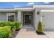 Inviting front entrance with a well-kept lawn and a black front door at 1976 Harvest Landing Cir, Lakeland, FL 33810