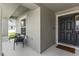 Cozy front porch with seating area next to the main door entrance at 1976 Harvest Landing Cir, Lakeland, FL 33810
