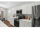 Well-lit kitchen featuring stainless steel appliances, white cabinetry, and modern countertops at 1976 Harvest Landing Cir, Lakeland, FL 33810