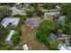 A high-angle view of a home showcasing its roof, yard size, and proximity to other properties at 208 Lake Dale Dr, Auburndale, FL 33823