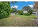 The expansive backyard features ample lawn space and a utility shed, providing plenty of room for outdoor activities at 208 Lake Dale Dr, Auburndale, FL 33823