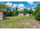 The large backyard offers endless possibilities, featuring a lush lawn, shade trees, and a convenient utility shed at 208 Lake Dale Dr, Auburndale, FL 33823