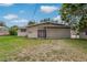 The back exterior view shows an attached garage, slider to backyard, and a fenced yard at 208 Lake Dale Dr, Auburndale, FL 33823