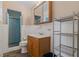 Bathroom with a walk-in shower, wooden sink vanity, and shelving at 208 Lake Dale Dr, Auburndale, FL 33823
