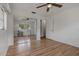 Bedroom features a ceiling fan, closet, window, and light wood grain flooring at 208 Lake Dale Dr, Auburndale, FL 33823