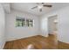 Bright bedroom featuring hardwood floors, a ceiling fan, and a window providing natural light at 208 Lake Dale Dr, Auburndale, FL 33823