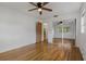 A cozy bedroom with hardwood floors, ceiling fan, and mirrored closet at 208 Lake Dale Dr, Auburndale, FL 33823