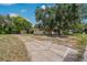 Exterior view of home and detached garage, showcasing a concrete driveway and beautiful mature shade trees at 208 Lake Dale Dr, Auburndale, FL 33823