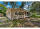 The home's backyard features a fenced in yard with mature trees at 208 Lake Dale Dr, Auburndale, FL 33823