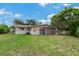 A backyard exterior view featuring the home's attached garage, a shed, and a fenced-in yard at 208 Lake Dale Dr, Auburndale, FL 33823