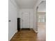Hallway featuring hardwood floors, neutral walls, and access to the front door and other rooms at 208 Lake Dale Dr, Auburndale, FL 33823