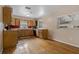 Functional kitchen featuring wooden cabinets, hardwood floors, and stainless steel appliances, providing a warm space at 208 Lake Dale Dr, Auburndale, FL 33823