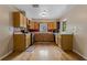Functional kitchen featuring wooden cabinets, hardwood floors, and stainless steel appliances, offering a warm space at 208 Lake Dale Dr, Auburndale, FL 33823