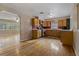 Bright kitchen showcases wood cabinets, stainless steel appliances, hardwood floors, and an open layout at 208 Lake Dale Dr, Auburndale, FL 33823