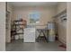 Laundry room with a washer, dryer, water heater, and storage shelves at 208 Lake Dale Dr, Auburndale, FL 33823