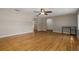 Bright living room showcasing hardwood floors, neutral paint, an open layout, and a ceiling fan at 208 Lake Dale Dr, Auburndale, FL 33823