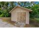 Tan shed with double doors and concrete blocks is perfect for storage at 208 Lake Dale Dr, Auburndale, FL 33823