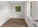 Small bedroom featuring wood-look floors and two windows at 216 Pike St, Auburndale, FL 33823