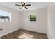 Bright bedroom featuring two windows, modern ceiling fan, and wood-look flooring at 216 Pike St, Auburndale, FL 33823