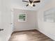 Cozy bedroom featuring wood-look flooring, ceiling fan, and natural light at 216 Pike St, Auburndale, FL 33823