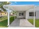 Attached carport providing covered parking with a concrete driveway at 216 Pike St, Auburndale, FL 33823