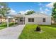 Charming home featuring a carport and well-maintained lawn at 216 Pike St, Auburndale, FL 33823