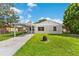 Charming single-story home featuring a carport and well-maintained lawn at 216 Pike St, Auburndale, FL 33823