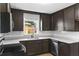 Renovated kitchen featuring dark cabinetry, stone countertops, and subway tile backsplash at 216 Pike St, Auburndale, FL 33823