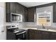 Modern kitchen with black appliances, sleek dark cabinets, and stylish backsplash at 216 Pike St, Auburndale, FL 33823