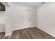 Neutral living room featuring wood-look floors and a white door at 216 Pike St, Auburndale, FL 33823