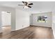 Bright living room with wood-look floors and a ceiling fan at 216 Pike St, Auburndale, FL 33823