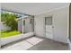 Covered patio offers a relaxing outdoor space with screen door and serene backyard views at 216 Pike St, Auburndale, FL 33823