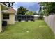 Expansive backyard with well-maintained lawn, screened-in pool, and partial perimeter fencing at 217 Shore Loop, Winter Haven, FL 33884