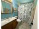 Well-lit bathroom with a shower and tub combination, plus plenty of storage at 217 Shore Loop, Winter Haven, FL 33884