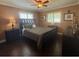 Cozy bedroom with ceiling fan, wood floors and a comfortable bed at 217 Shore Loop, Winter Haven, FL 33884