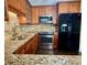 Updated kitchen featuring granite countertops, stainless steel appliances, and custom wood cabinets at 217 Shore Loop, Winter Haven, FL 33884