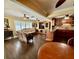 Open living area featuring hardwood floors, large windows, and access to the kitchen at 217 Shore Loop, Winter Haven, FL 33884