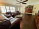Cozy living room with hardwood floors, natural light, and comfortable leather furniture at 217 Shore Loop, Winter Haven, FL 33884