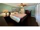 Comfortable main bedroom with hardwood floors, large windows, and a spacious closet at 217 Shore Loop, Winter Haven, FL 33884