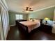 Comfortable main bedroom with hardwood floors, large windows, and a spacious closet at 217 Shore Loop, Winter Haven, FL 33884