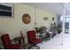 Covered patio area featuring comfortable seating and decorative art on the walls at 217 Shore Loop, Winter Haven, FL 33884