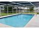 Inviting screened-in pool with clear blue water and spacious patio area at 217 Shore Loop, Winter Haven, FL 33884