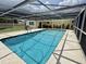 Beautiful screened-in pool with clear blue water and backyard views at 217 Shore Loop, Winter Haven, FL 33884