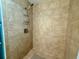 Tiled shower with a sleek, modern shower head and storage shelving at 217 Shore Loop, Winter Haven, FL 33884