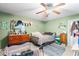 Cozy bedroom with ceiling fan, decorated dresser and coordinated décor at 2282 Firestone Pl, Winter Haven, FL 33884