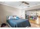 Cozy bedroom with a comfortable bed and a view into the expansive living room at 2282 Firestone Pl, Winter Haven, FL 33884