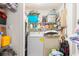 Functional laundry room with washer, dryer, and storage shelving at 2282 Firestone Pl, Winter Haven, FL 33884
