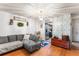 Comfortable living room with sectional sofa, hardwood floors, and decorative wall art at 2282 Firestone Pl, Winter Haven, FL 33884